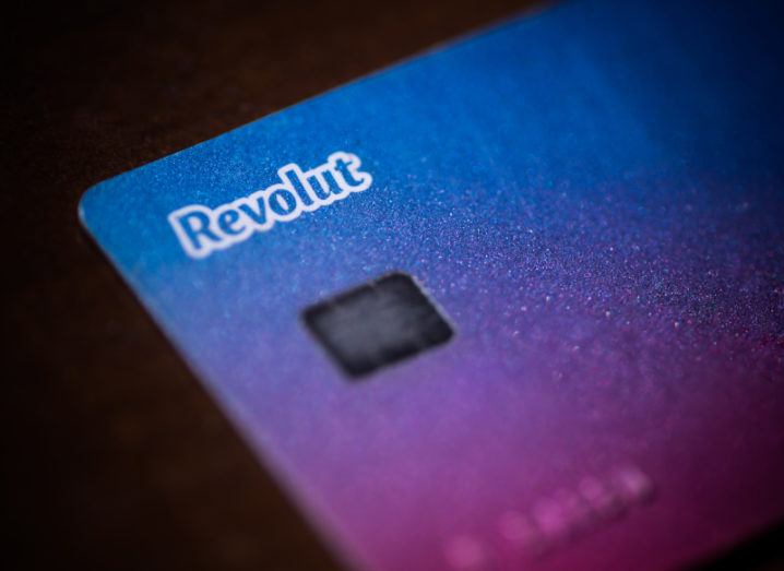 Close-up of a Revolut card with its blue and purple gradient.