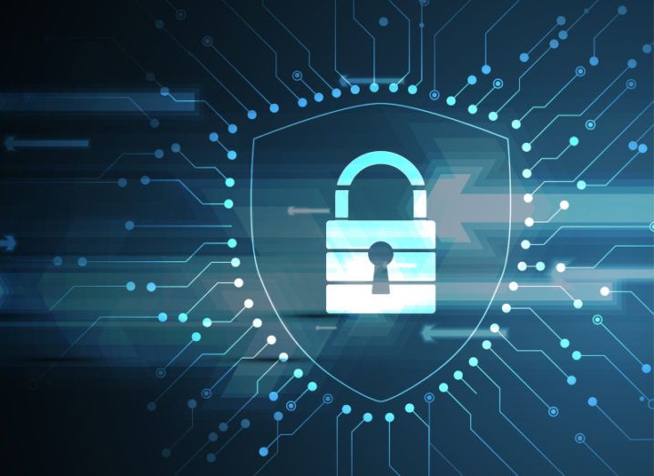 A graphic of a padlock inside a shield, surrounded by electrical connections, representing cybersecurity.