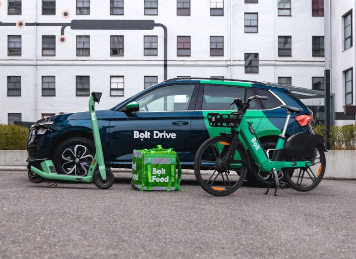 A promotional image of a car from Bolt’s Bolt Drive service, a Bolt e-scooter, a Bolt Food delivery bag, and a Bolt e-bike.