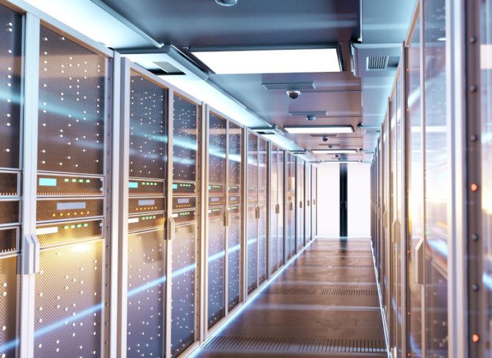 Image of a data centre, with servers lining a corridor.