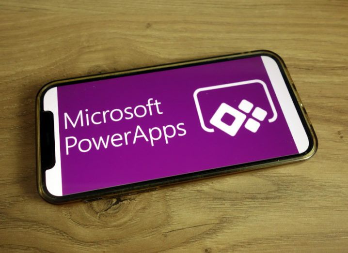 Microsoft Powers Apps logo on a smartphone.