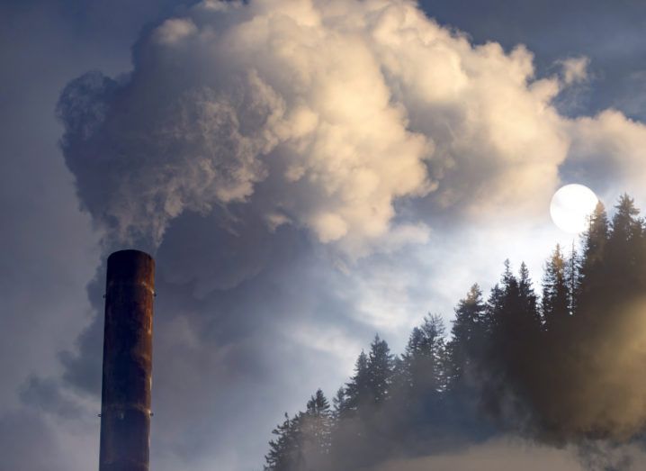 A tower is pictured billowing smoke into the air. The smoke is travelling into a forest of trees, showing the company’s negative impact on the environment.