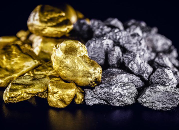 Nuggets of silver and gold are piled on top of a black surface. The nuggets are shining and look valuable but their use could also offer a new way of storing hydrogen energy.