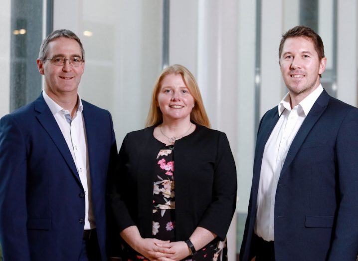 The founding members of Nua Surgical are pictured. Padraig Maher, Marie-Therese Maher and Barry McCann are standing beside each other and smiling at the camera.