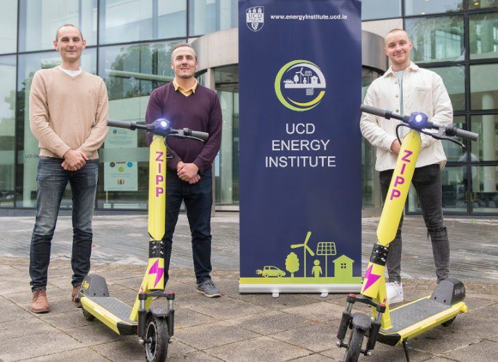 Prof Andrew Keane, Dr Paul Cuffe and Charlie Gleeson standing outside UCD at the launch of their research project, with two Zipp e-scooters in front of them.