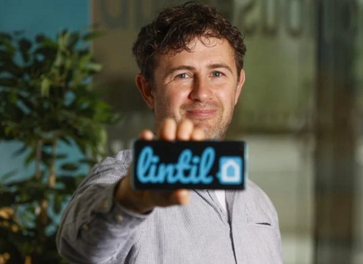 Lintil co-founder and CEO Emmet Creighton holding a card with Lintil branding on it.