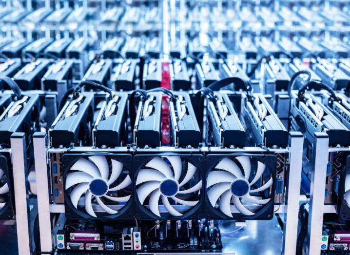 Close-up of fans installed in computer systems inside a crypto mining farm.