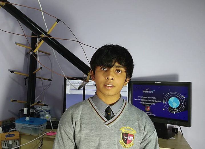 Secondary school student Hari Pravanam standing in front of his project and a computer with SciFest written on the screen.