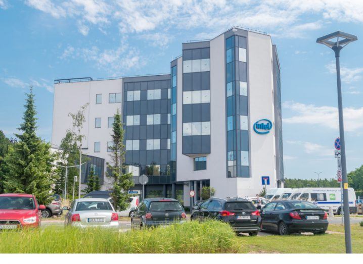 The exterior of the Intel Gdansk office in Poland with cars visible in the carpark.