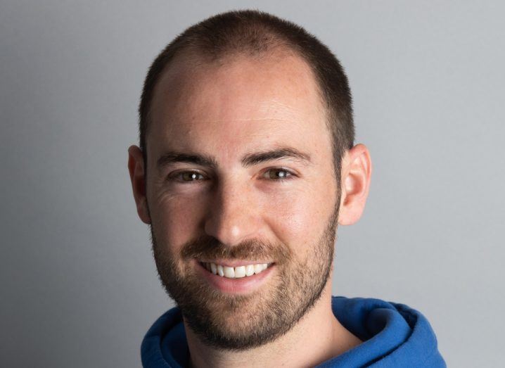 Headshot of Raylo CEO Karl Gilbert smiling. He is wearing what appears to be a blue hoodie.