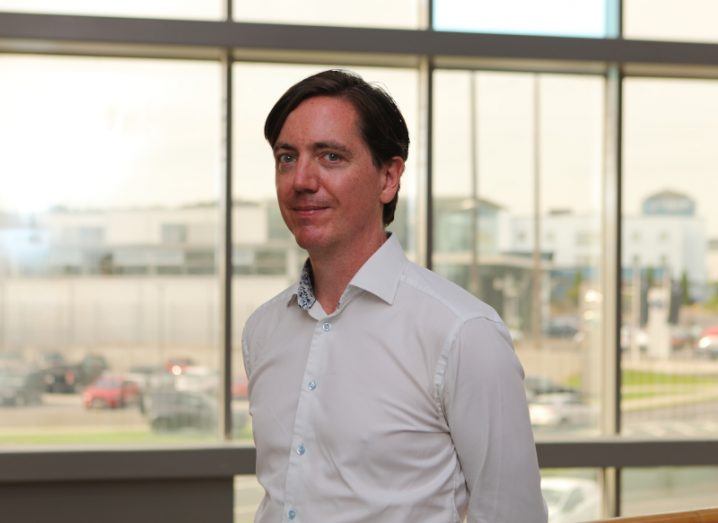 A man in a white shirt stands in front of a bright window. He is Keith Lynch, country manager of Red Hat in Ireland.