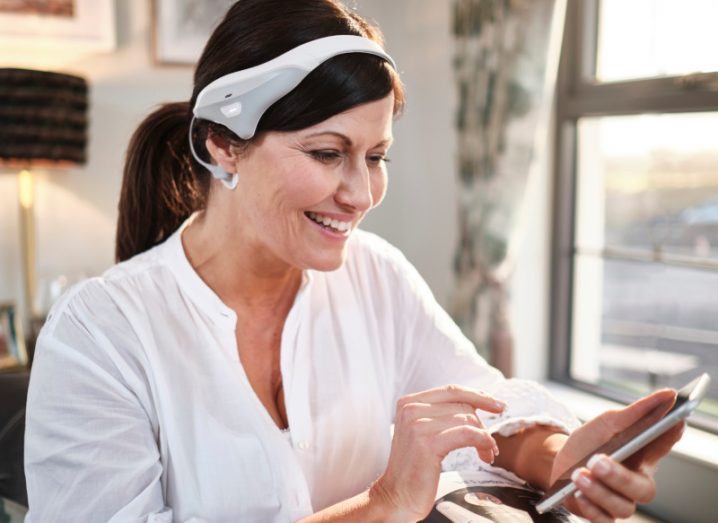 Woman using Modius Sleep device by Neurovalens that was given FDA clearance.