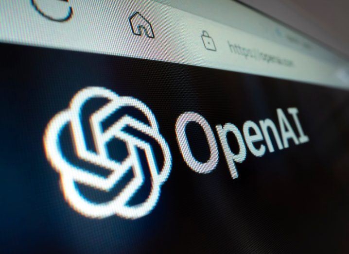 The OpenAI logo on a screen, with a search bar visible on the top.