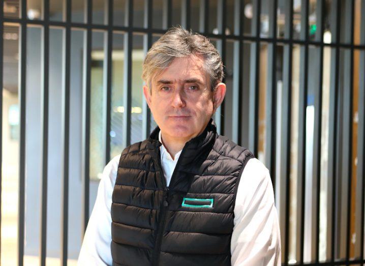 A headshot of a man in a white shirt and a black gilet. He is Ray McGann, MD of HPE Ireland.