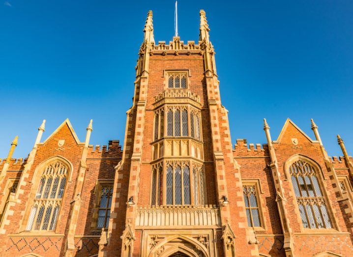 A close-up from below of the main quad at Queen's University Belfast against a clear blue sky.