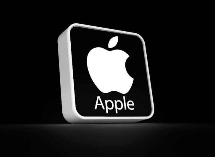 The Apple logo on a black square in a black background.