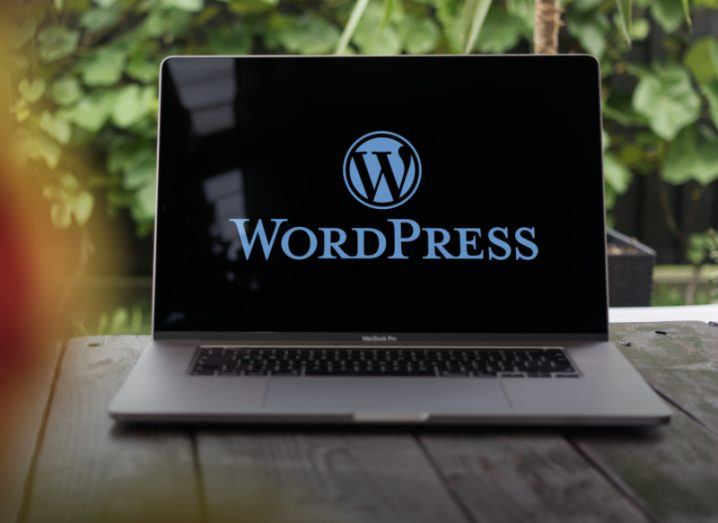 A laptop with the Automattic-owned WordPress logo on the screen.