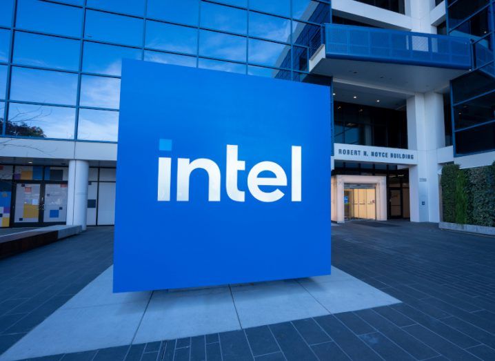 The Intel logo on a blue square sign in front of a building.