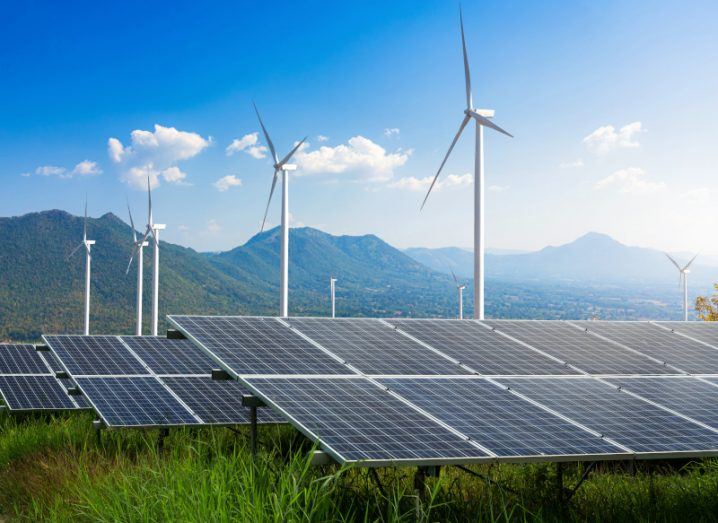 Windfarms and solar panels in a field.