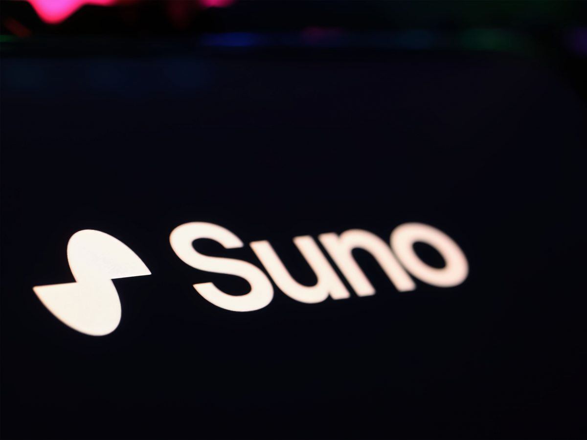Suno logo and branding on a dark smartphone screen.