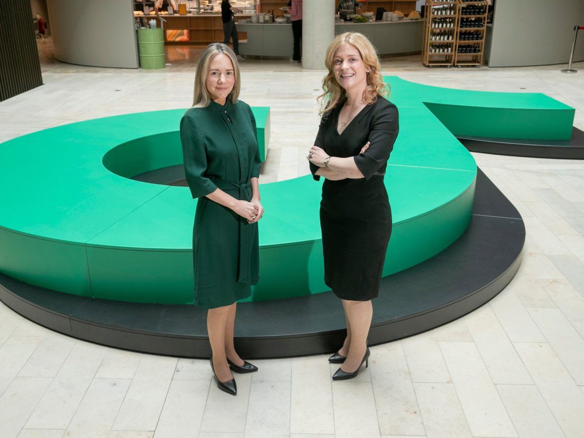 Susan Moss and Elaine Fox of TikTok standing in an indoor space that appears to be an office building.