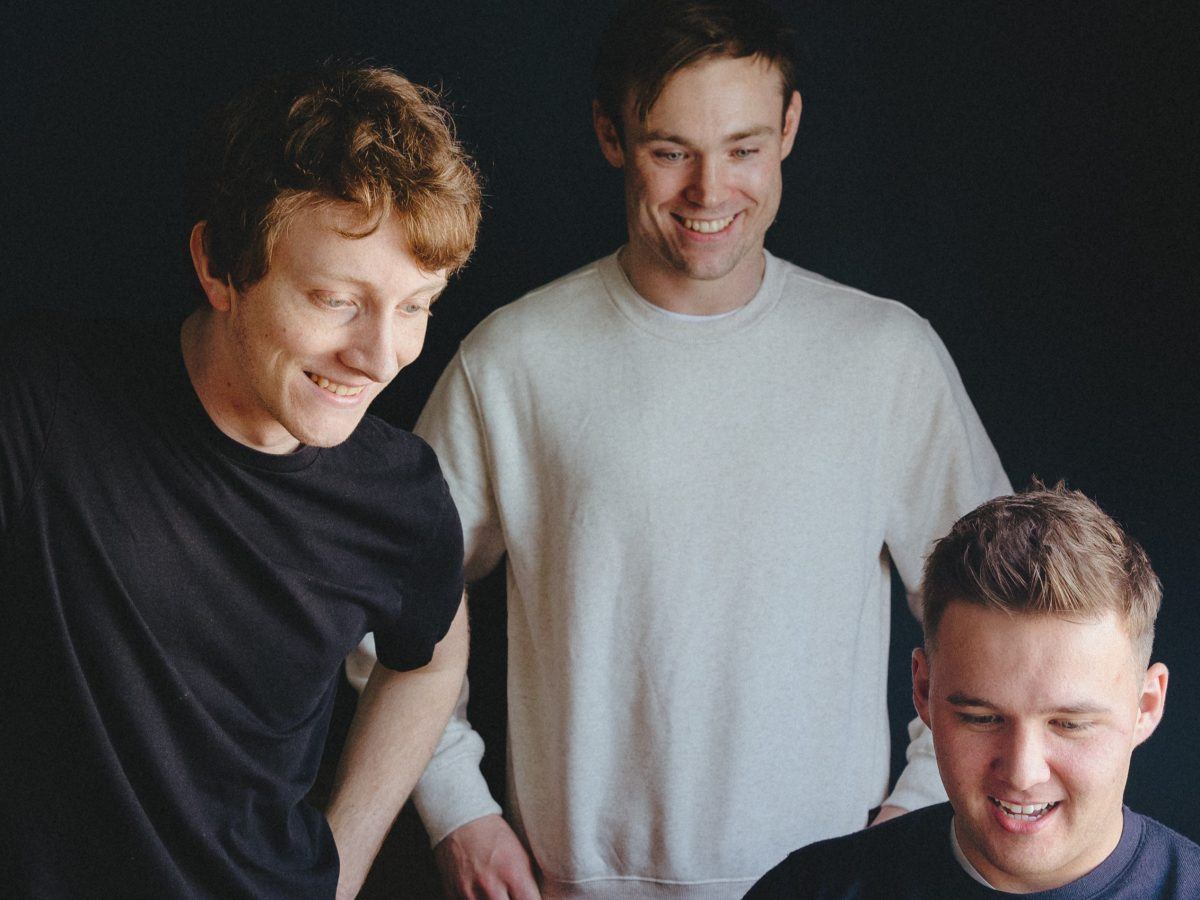 Photo of the three founders of Jamango against a dark background.