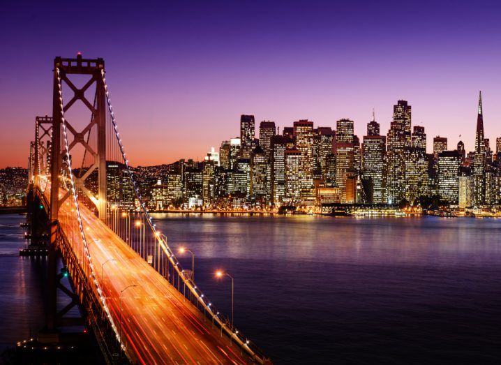 San Francisco skyline and Bay Bridge at sunset.