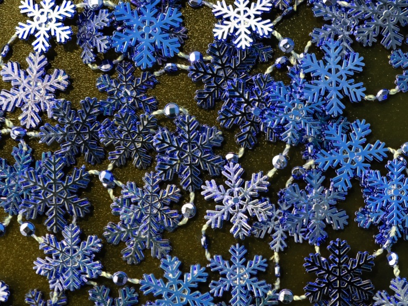 Multiple snowflakes of different colours on a brown surface. Used for the context of the Snowflake breaches.