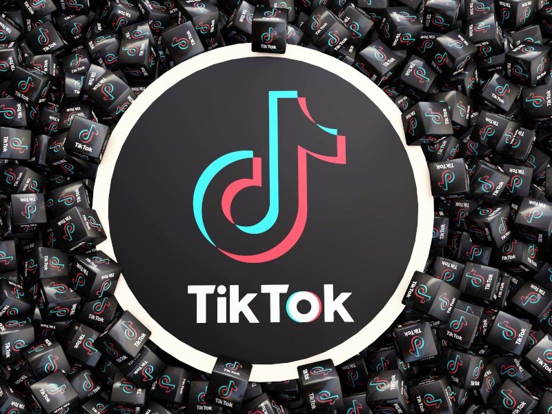 The TikTok logo on a circle surrounded by squares with the same logo on them.