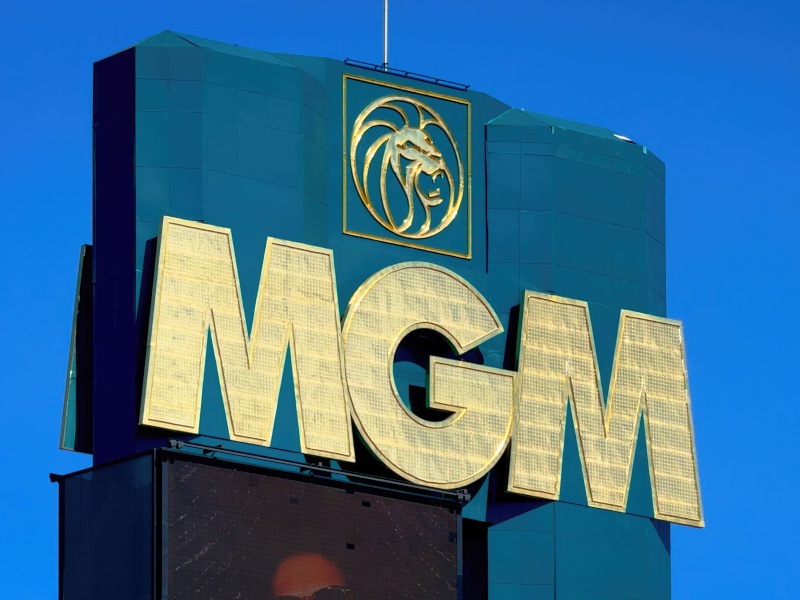 The MGM logo on the side of a tall building, with a blue sky in the background.