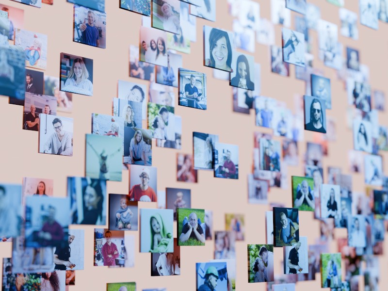 Multiple photos of people on a pale wall. Used for the concept of AI-generated content on social media.