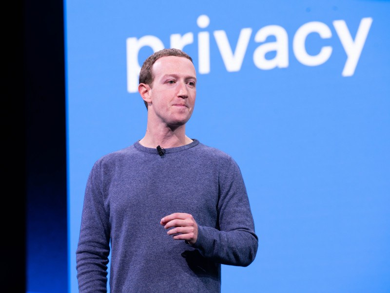 Mark Zuckerberg speaking with the word privacy on the screen behind him.
