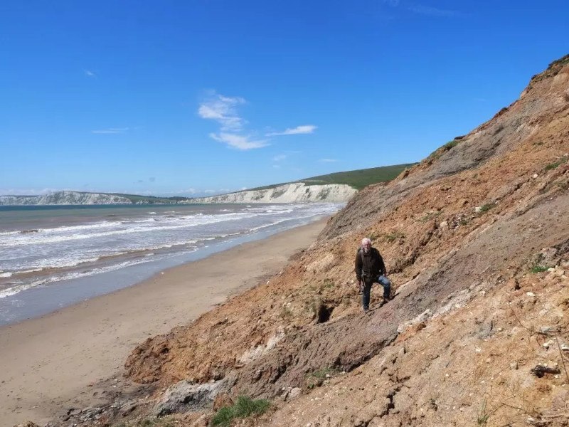 Photo of a man standing in the distance at a beach in the Isle of Wight.