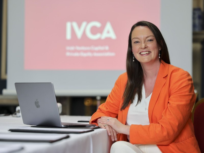 Headshot of IVCA director-general Sarah-Jane Larkin sitting at a desk with a laptop in front of her.