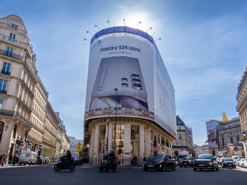 Samsung ad on a big board on a building in a busy city centre..