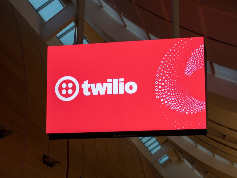 Twilio logo on a screen in an airport.