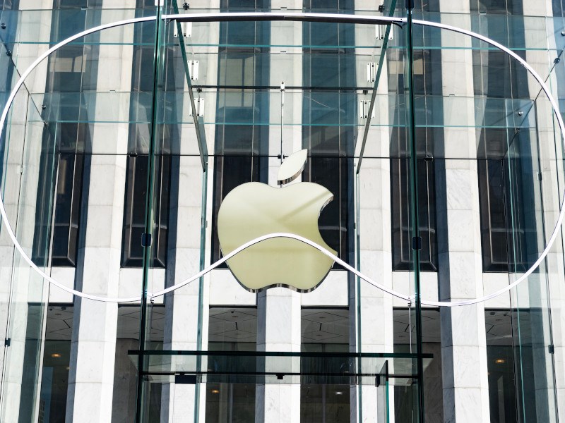 Apple logo behind a structure in the shape of the Vision Pro headset.