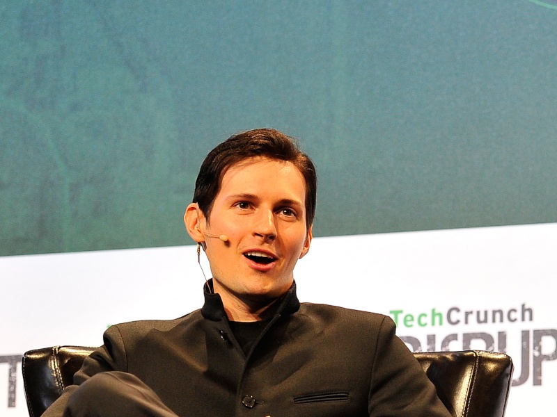 Telegram CEO Pavel Durov sitting on a black chair with a microphone connected to his ear.