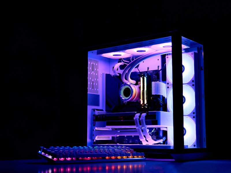 A PC with purple light glowing inside it with a dark background. Used for the concept of AI-capable PCs.