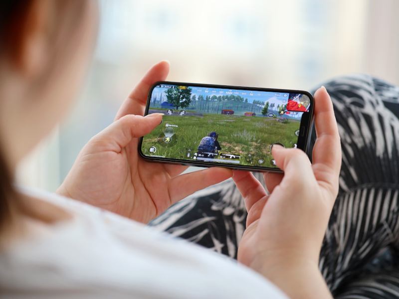 A person playing a video game on their smartphone.