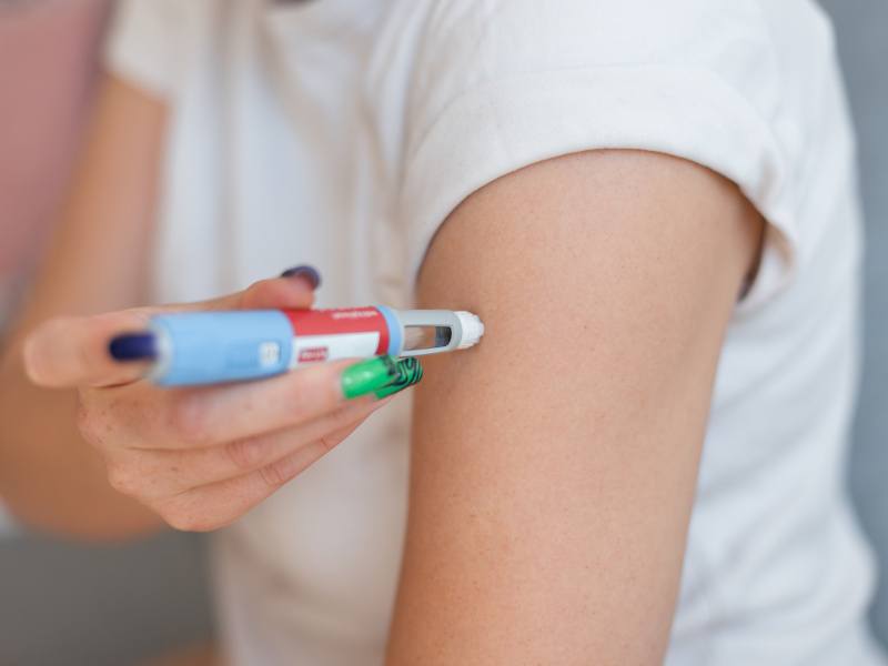 A person injecting themselves in the arm with the weight-loss drug Ozempic.