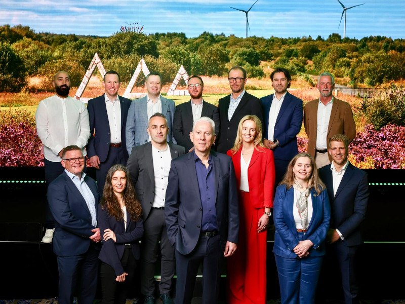 Multiple men and women standing together in front of a screen showing a landscape. They are part of the Bord na Móna Accelerate Green Programme.