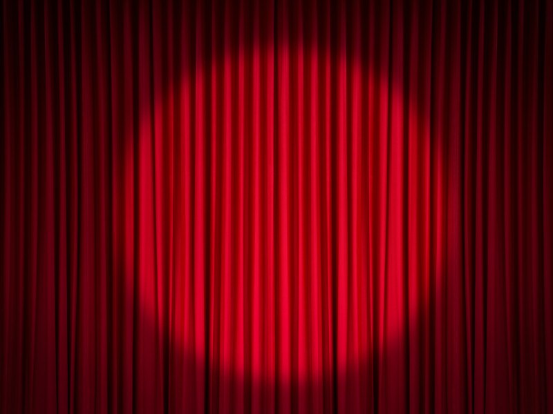 Spotlight on a red stage curtain.