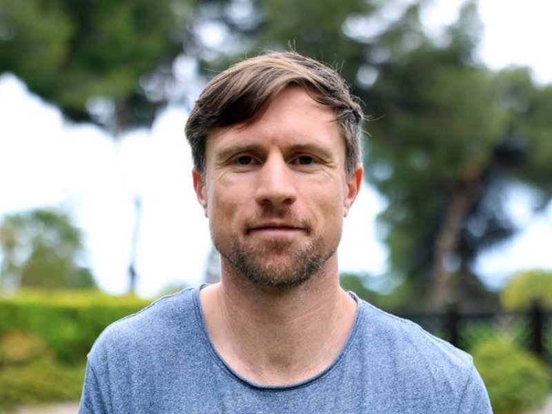 Headshot of Ciarán Murray, founder and CEO of Olas, in the outdoors.