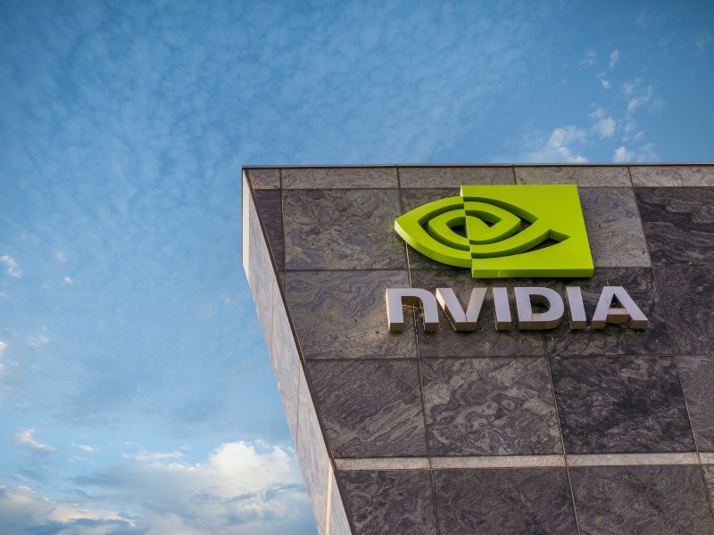 Nvidia logo on a building with blue sky in the background.