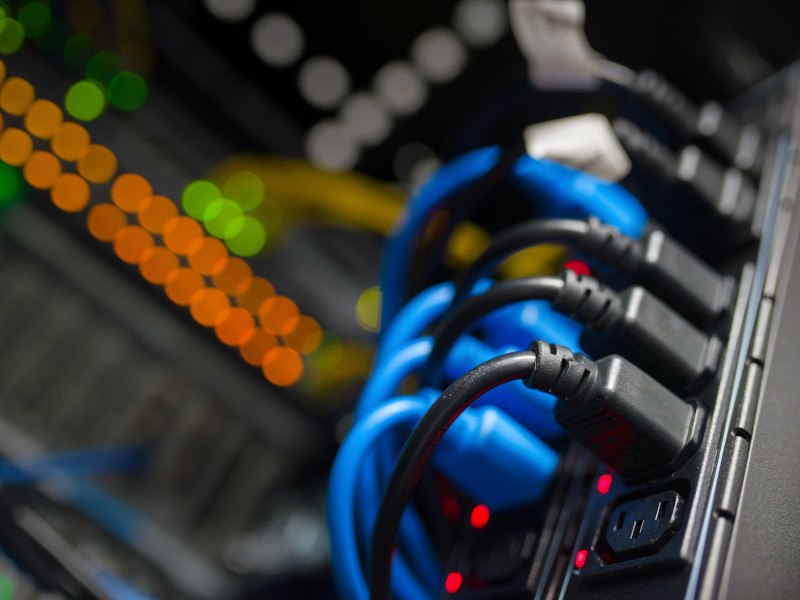 Close-up of plugs in a server at a data centre.