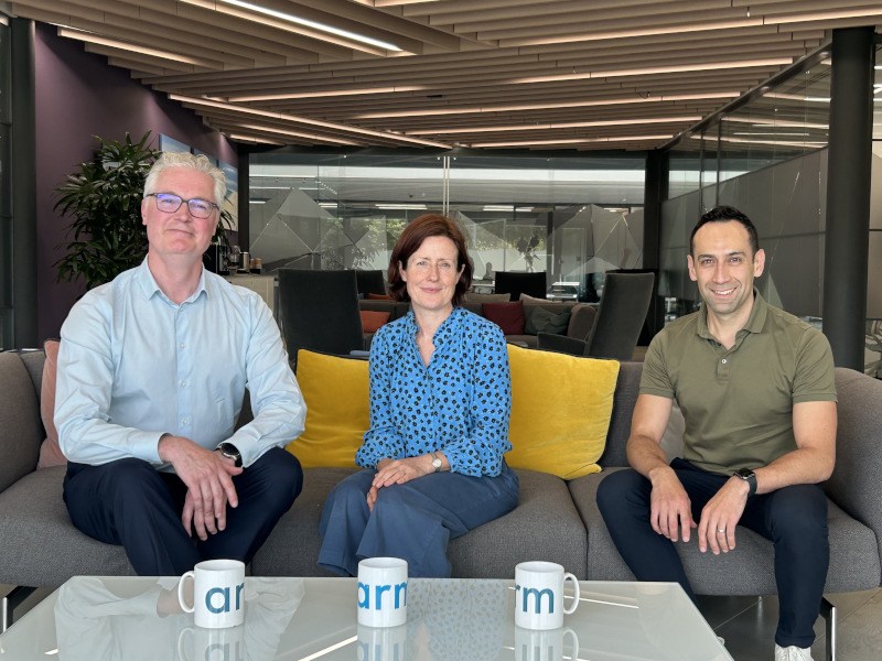 Two men and a woman sitting on a couch in front of a table with three cups on it. They are part of Lero and Arm.