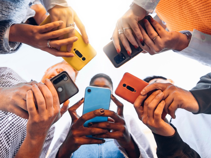 Multiple people looking down at their mobile phones. Used for the launch of Sky Mobile in Ireland.