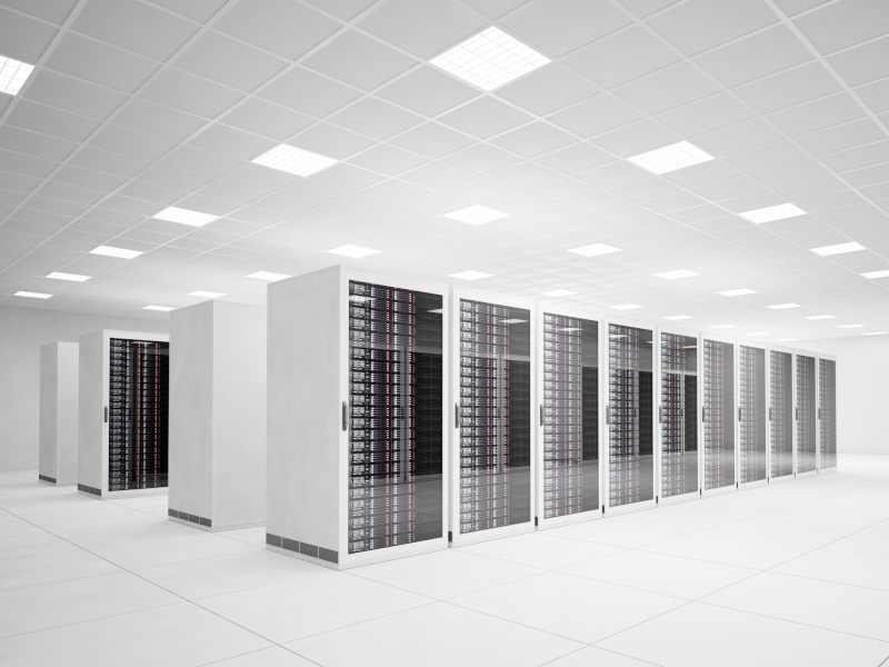 The inside of a data centre with rows of servers inside a white room, with tiles on the floor and ceiling.