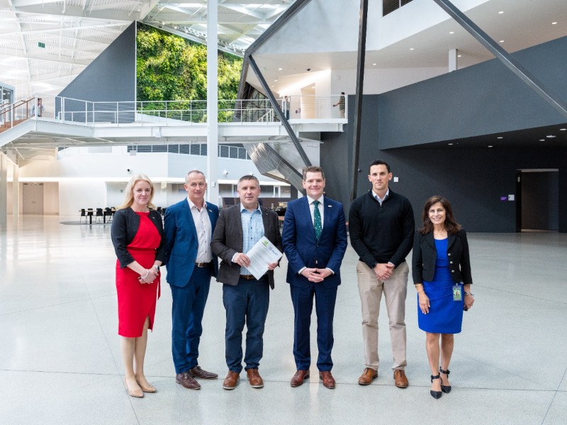 Six people standing facing the camera at the Silicon Valley HQ.